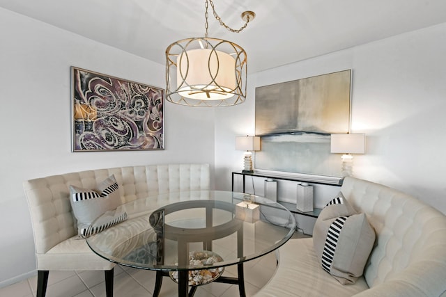 dining space featuring light tile patterned flooring and a notable chandelier