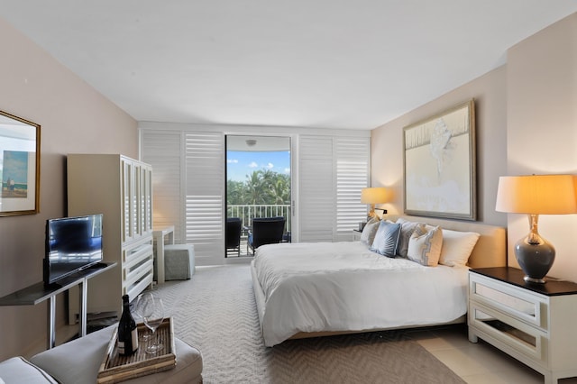 bedroom with light tile patterned floors and access to exterior