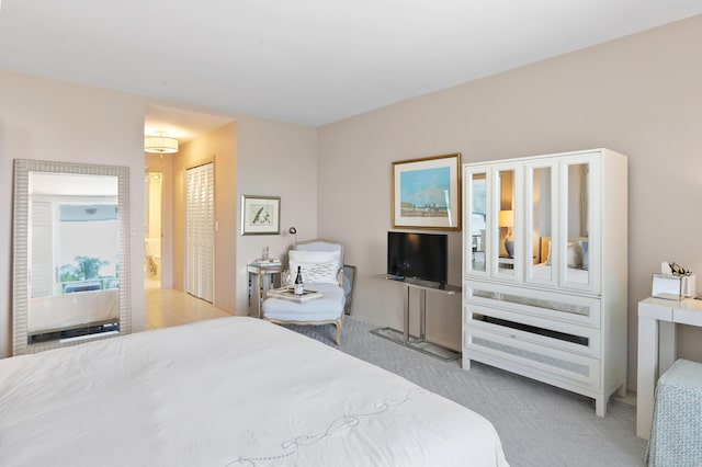 bedroom featuring light colored carpet