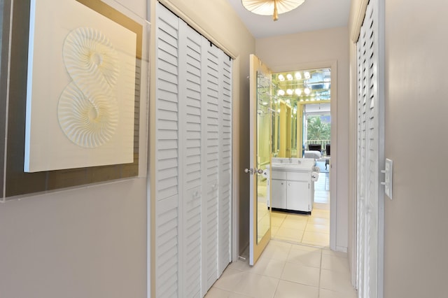 hallway with light tile patterned floors and a sink