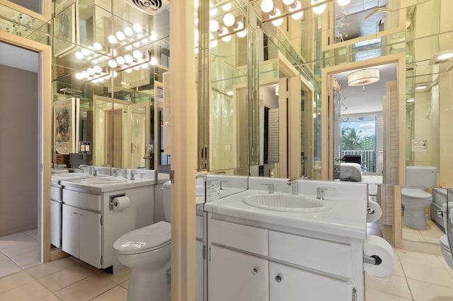 bathroom with double sink vanity, tile patterned flooring, and toilet