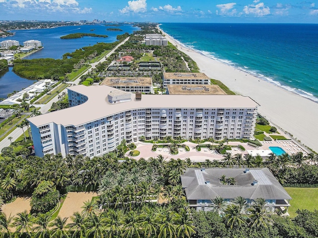 bird's eye view with a water view and a beach view