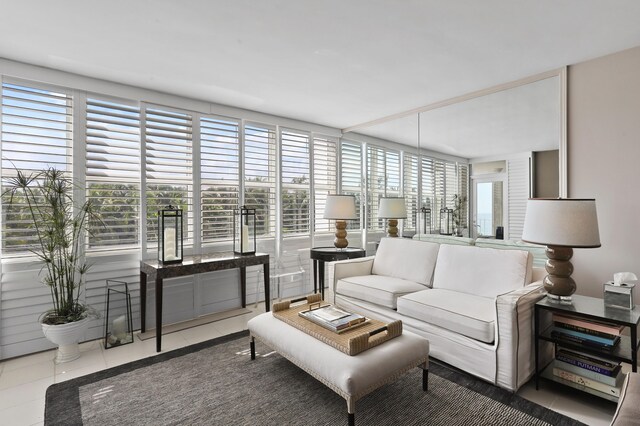 living area featuring tile patterned flooring and floor to ceiling windows