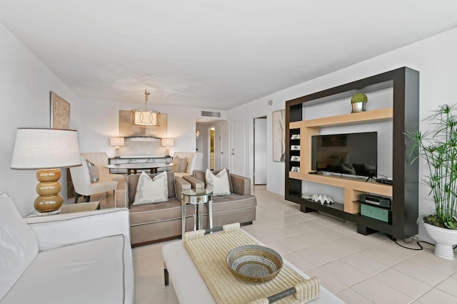 living room featuring visible vents and light tile patterned flooring