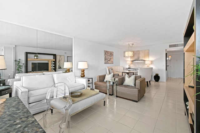 living area with visible vents and light tile patterned floors