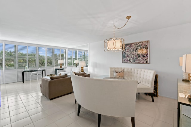 dining space with light tile patterned floors and a wall of windows