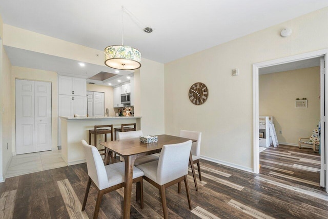 dining area featuring wood-type flooring and sink