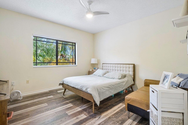 bedroom featuring wood-type flooring, a textured ceiling, and ceiling fan