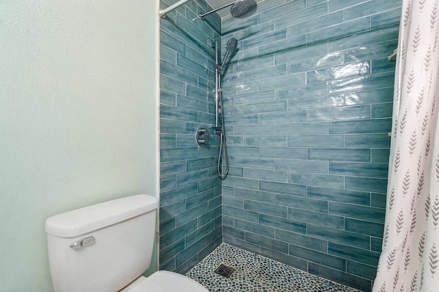 bathroom featuring curtained shower and toilet