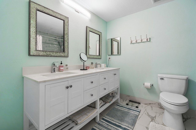 bathroom featuring toilet, tile patterned flooring, and dual bowl vanity