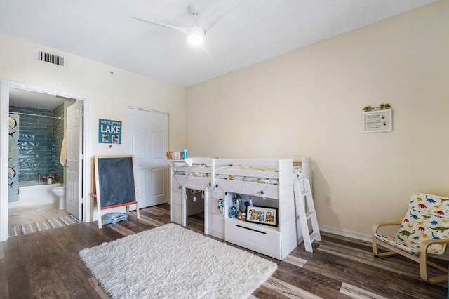 bedroom with dark hardwood / wood-style floors, ceiling fan, and connected bathroom