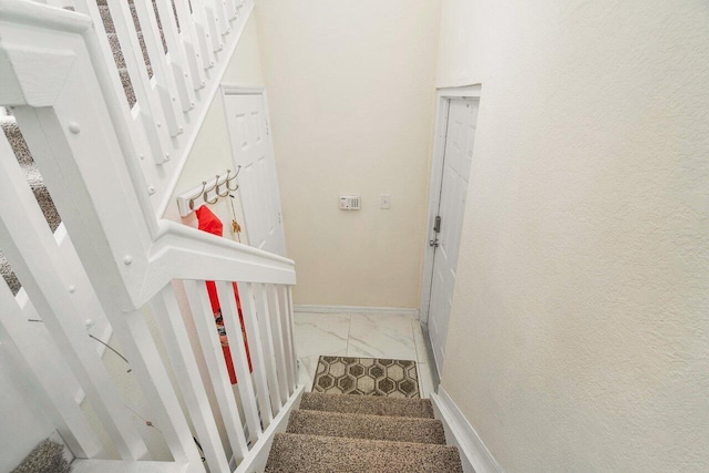 staircase with tile patterned floors