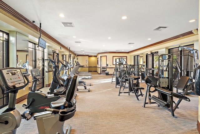 exercise room with crown molding, light carpet, and a wealth of natural light