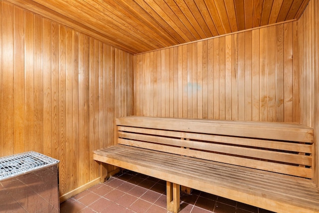 view of sauna with tile patterned floors, wooden walls, and wooden ceiling