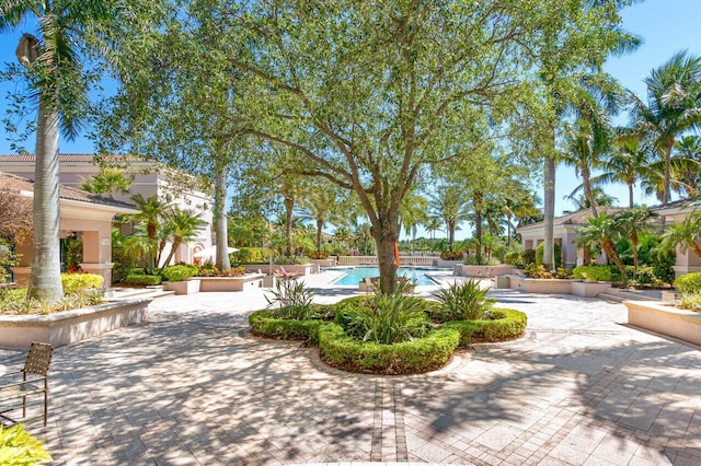 surrounding community with a pool and a patio area