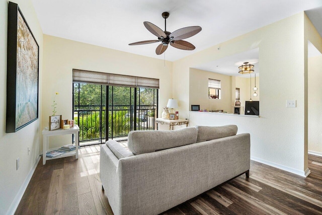 living room featuring hardwood / wood-style flooring and ceiling fan