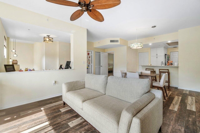 living room with dark hardwood / wood-style floors and ceiling fan