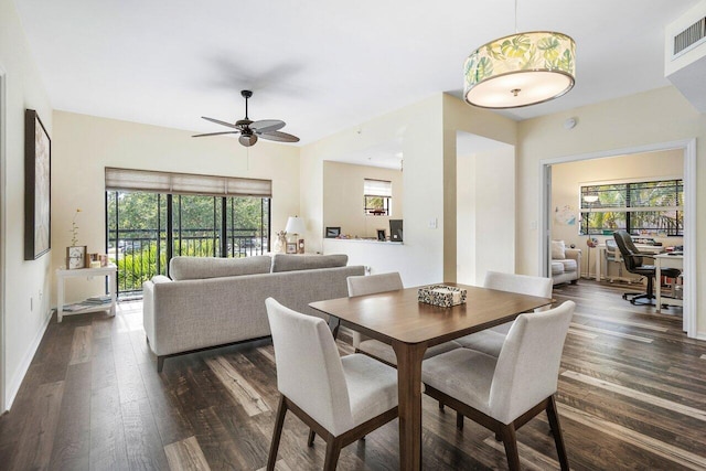 dining area with dark hardwood / wood-style floors and ceiling fan