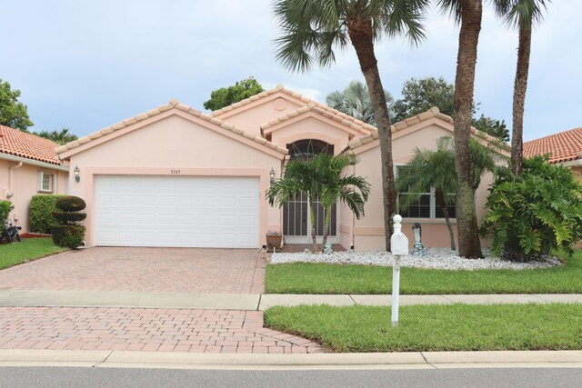 mediterranean / spanish home with a garage