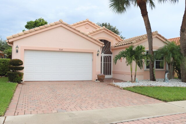 mediterranean / spanish-style home featuring a garage