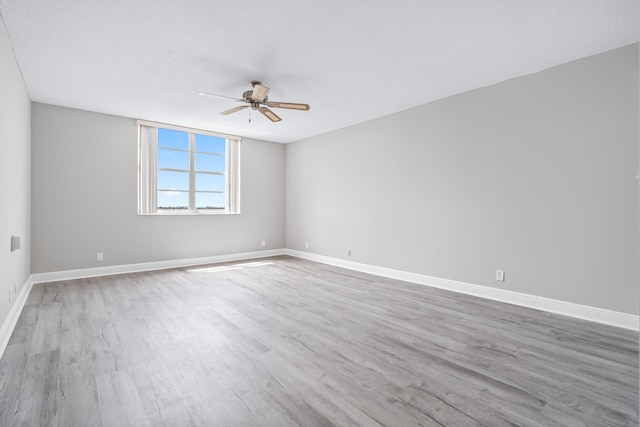 empty room with ceiling fan and hardwood / wood-style floors