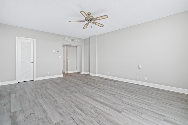 empty room featuring light hardwood / wood-style flooring and ceiling fan