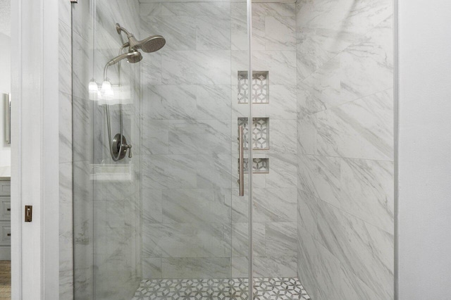 bathroom featuring vanity and a shower with door