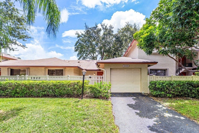 view of front of house with a front lawn and a garage