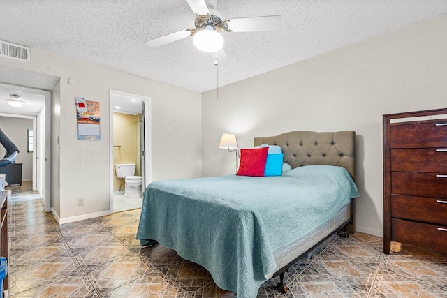 tiled bedroom featuring ensuite bath, a textured ceiling, and ceiling fan