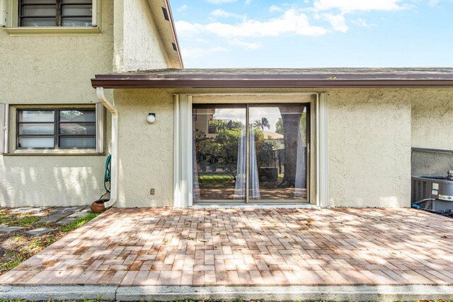 property entrance featuring central AC unit and a patio area