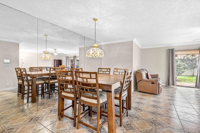 tiled dining space featuring ceiling fan, ornamental molding, and a textured ceiling