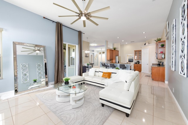 living area with light tile patterned floors, recessed lighting, baseboards, and ceiling fan