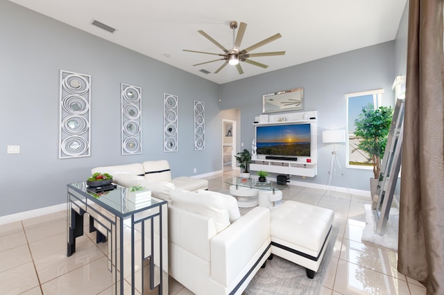 living area featuring visible vents, baseboards, and a ceiling fan