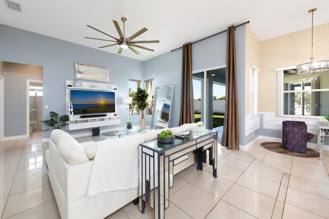 tiled living room with visible vents, baseboards, and ceiling fan with notable chandelier