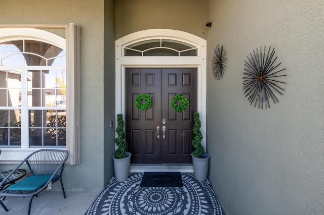 property entrance with stucco siding