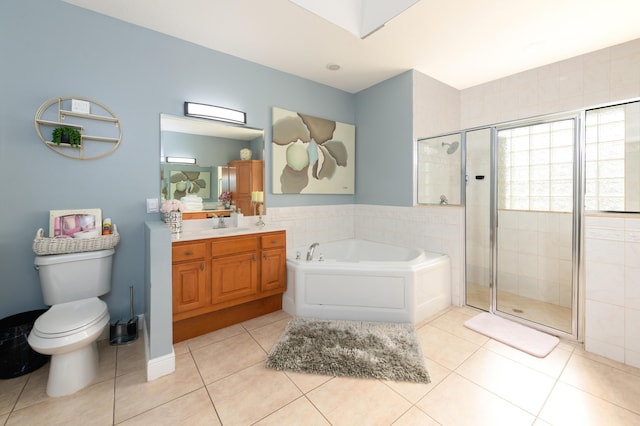 bathroom with vanity, a stall shower, tile patterned flooring, a garden tub, and toilet