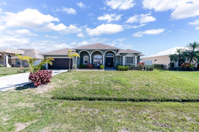 view of front of property with a garage and a front yard