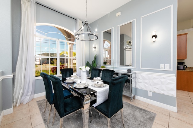 dining area with light tile patterned flooring and a notable chandelier