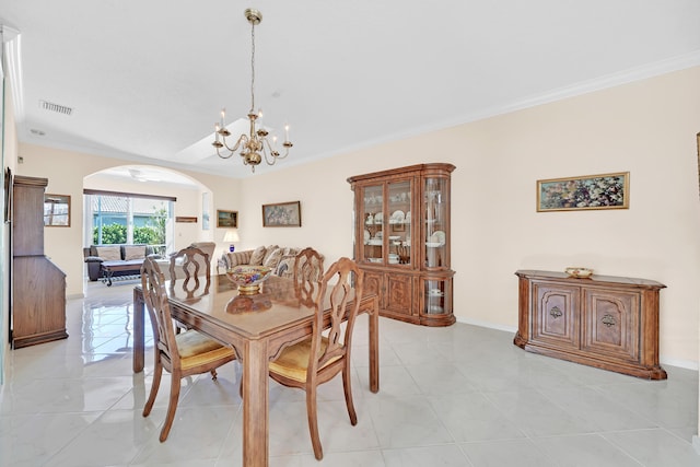 tiled dining room with a notable chandelier and ornamental molding