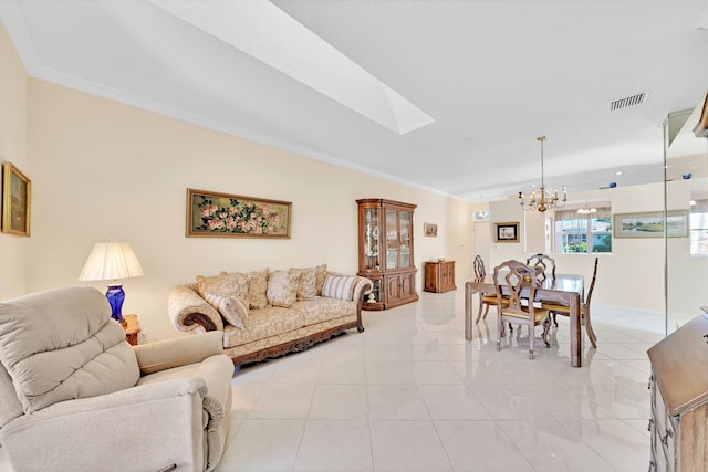 living room with ornamental molding, a chandelier, light tile patterned floors, and a skylight