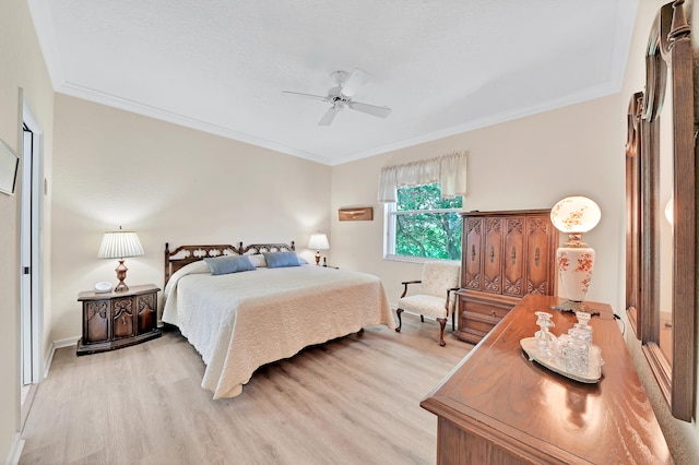 bedroom with light hardwood / wood-style flooring, ceiling fan, and crown molding