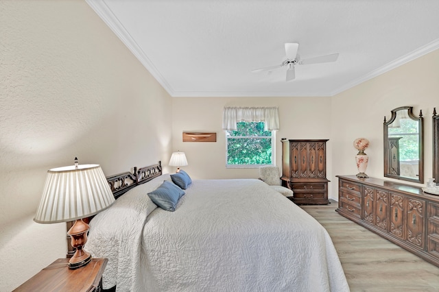 bedroom with ceiling fan, crown molding, and light hardwood / wood-style floors