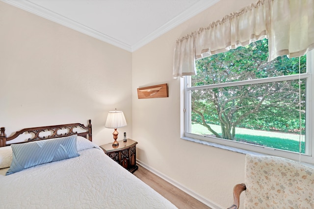 bedroom featuring crown molding and wood-type flooring