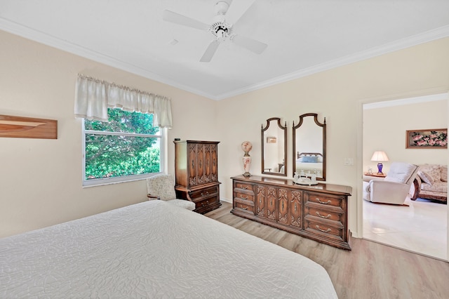 bedroom featuring ceiling fan, light hardwood / wood-style floors, and ornamental molding