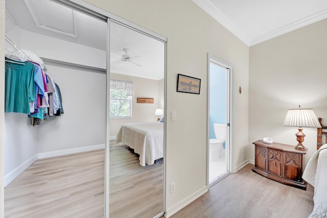 bedroom with ceiling fan, light wood-type flooring, and connected bathroom