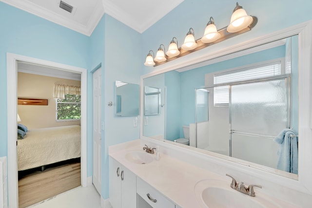 bathroom featuring toilet, dual vanity, crown molding, and wood-type flooring