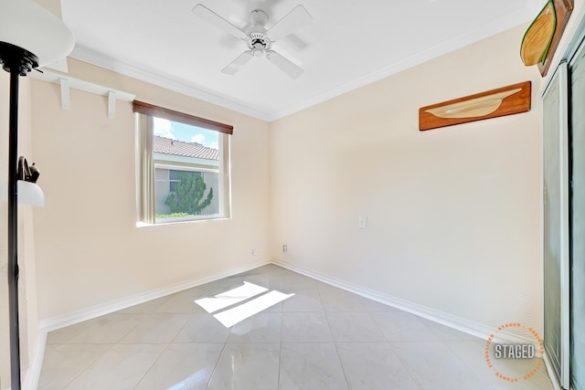 tiled spare room with ceiling fan and crown molding