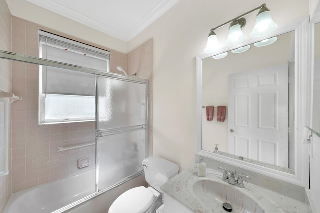 full bathroom with crown molding, toilet, shower / bath combination with glass door, and vanity