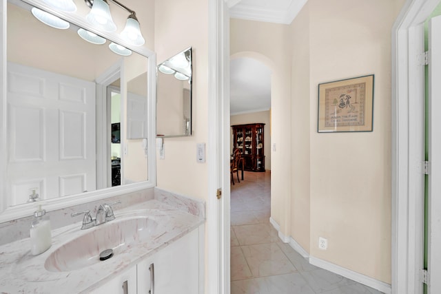 bathroom with tile patterned floors, crown molding, and vanity