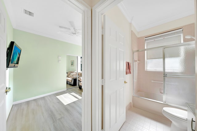 full bathroom with toilet, combined bath / shower with glass door, hardwood / wood-style floors, ornamental molding, and ceiling fan